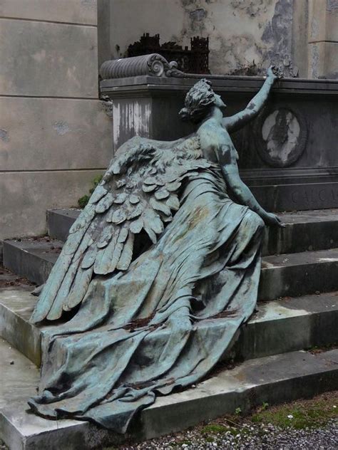 An Angel Statue Sitting On Top Of Steps Next To A Building