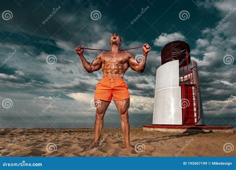 Fit Athlete Bodybuilder On The Beach Attractive Young Man Lifeguard