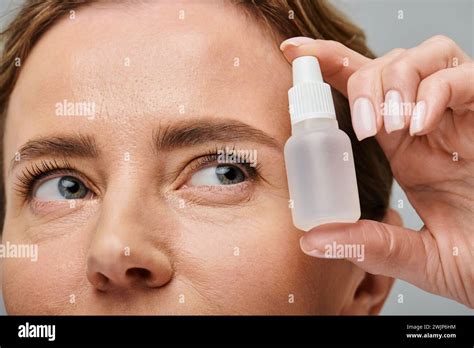 Close Up Of Joyous Beautiful Woman With Blonde Hair Holding Eye Drops