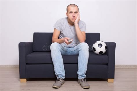 Bored Soccer Fan With Ball Watching Game On Tv Stock Image Image Of