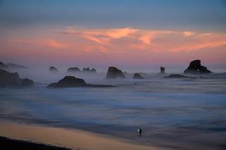 Lone surfer leaving Indian Beach as the fog and mist rolls… | Flickr