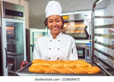 Smiling African Female Bakers Looking Camerachefs Stock Photo