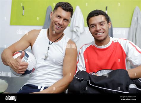 Mature Coach And Teen Footballer In Changing Room Stock Photo Alamy