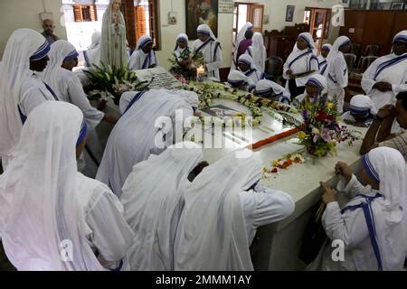 Nuns Pray Beside The Tomb Of Saint Teresa At The Missionaries Of