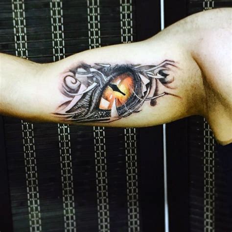 Little very realistic colored fantasy dragon eye tattoo on arm ...