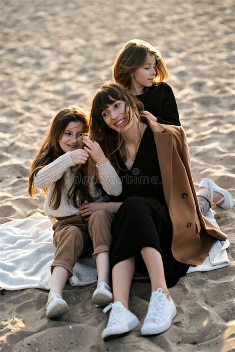 Portrait Of A Happy Young Woman With Her Daughter On The Beach At