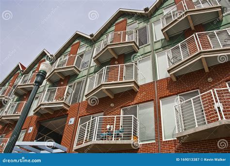 Perspective View Of A Red Brick And Green Wood Three Stacked Apartment