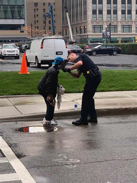 Officer Helps Homeless Man Struggling To Shave Over Street Puddle