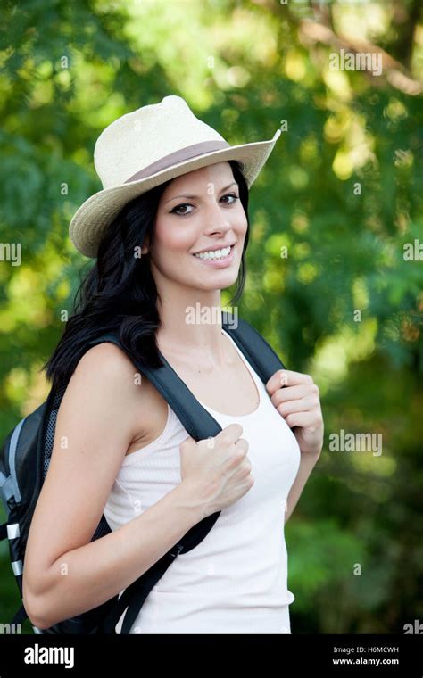 Brunette Woman With Straw Hat Walking Through The Woods Stock Photo Alamy