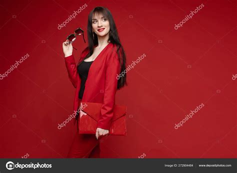 Side View Of Glamorous Brunette Posing In Red Smart Suit Stock Photo By Studioluckyaa