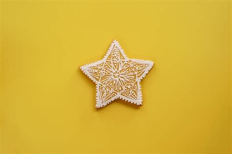 Premium Photo Glazed Openwork White Gingerbread Star Lies On A Yellow