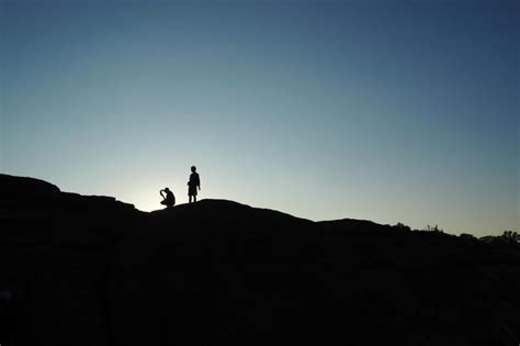 Free Stock Photo Of Two People Silhouetted Standing On Hilltop