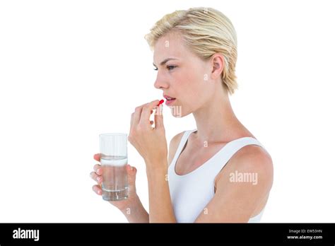 Pretty Blonde Woman Holding Glass Of Water And Ready To Swallow Red Pill Stock Photo Alamy