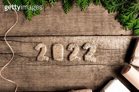 Numbers On An Old Brown Wooden Table With Gifts And Green Branches