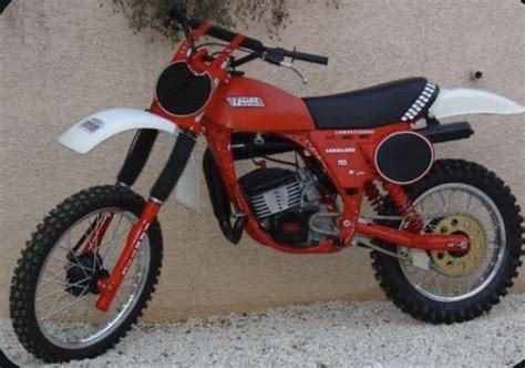 A Red And White Dirt Bike Parked Next To A Wall