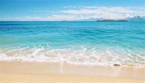 Sandy Beach With A Blue Ocean In The Background Light Green Hue Water