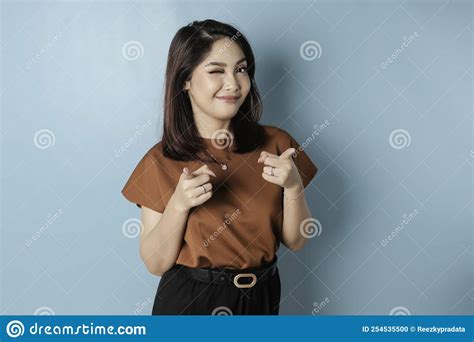 Young Beautiful Asian Girl Standing Over Isolated Blue Background Pointing Fingers To Camera