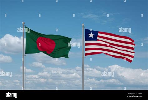 Liberia And Bangladesh Flags Waving Together In The Wind On Blue Cloudy