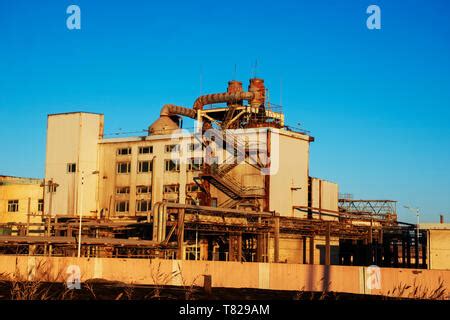 Old Abandoned Overgrown Factory With Rusty Remains Of Industrial