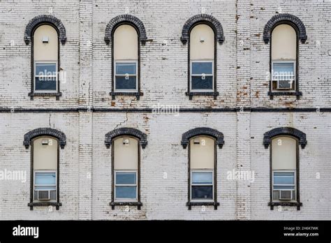 Eight Windows Against Brick Wall Of Abandoned Building In Historic