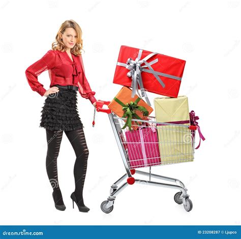 Attractive Woman Pushing A Shopping Cart Royalty Free Stock Photography