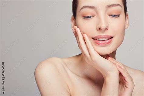 Sensual Smiling Pretty Girl With Brown Hair Clean Fresh Skin Naked Shoulders Touches Her Face By