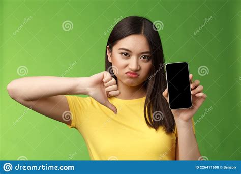 Close Up Disappointed Upset Asian Girl Judging Bad Awful App Show Smartphone Screen Thumb Down