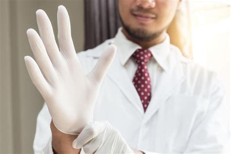 Premium Photo Midsection Of Doctor Wearing Glove In Hospital