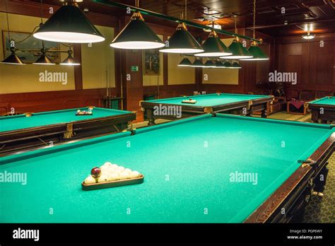 A Pool Table, set up for a game A game of 8 Ball racked and ready to go ...