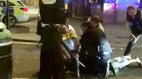 Moment Police Tackle Frenzied Knifeman On Busy Street After He