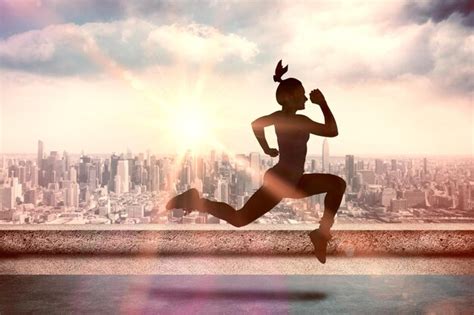 Premium Photo Fit Brunette Running And Jumping Against Sun Shining Over City