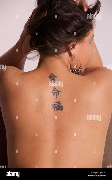 Beautiful Brunette Girl In The Studio Topless Showing Tattoo Stock Photo Alamy