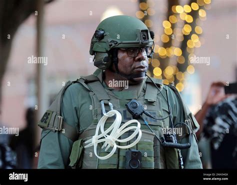 A police officer watches protesters in downtown Rock Hill, S.C. on ...