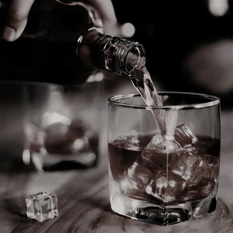 Someone Is Pouring Water Into A Glass Filled With Ice Cubes