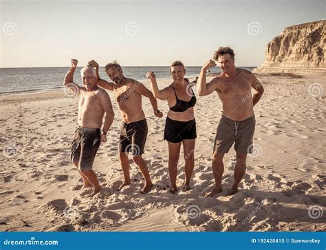 Group Of Mature Happy Active Adults Having Fun In The Beach Long Time