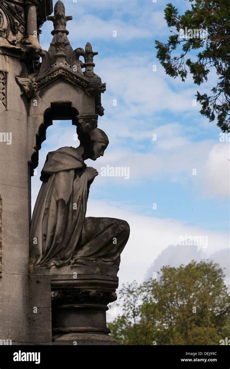 Statue of mourning woman on grave in the Père Lachaise Paris France