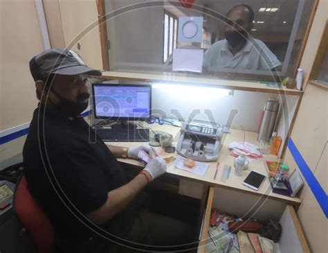 Image Of A Bank Employee Working Inside A Bank During A Day