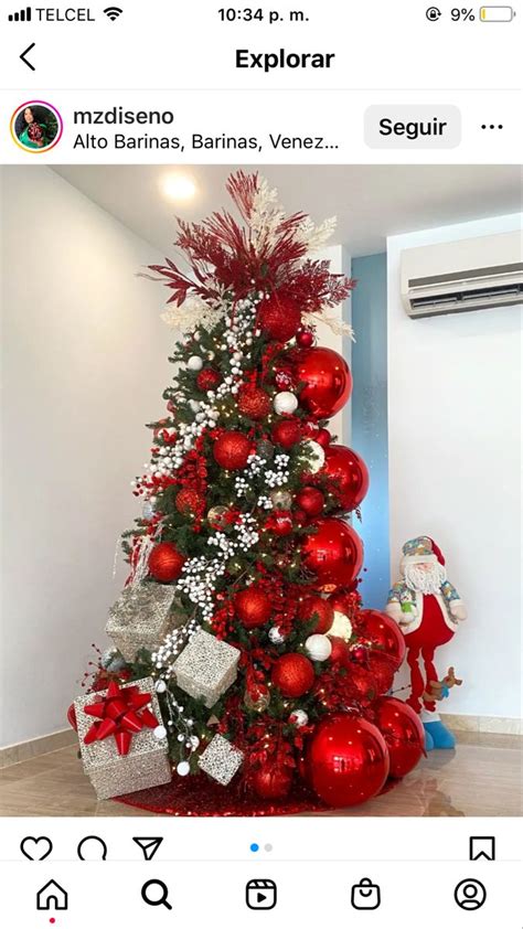 The Christmas Tree Is Decorated With Red And White Ornaments