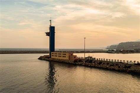 Premium Photo | A lighthouse on a pier at sunset