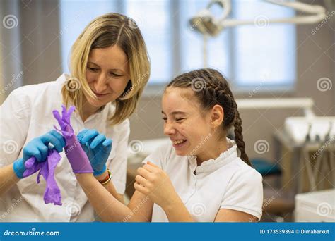 The Dentist With The Help Of A Carpule Syringe Injects Anesthesia Into