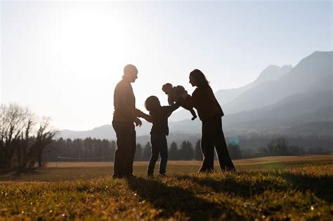 Free Photo | Full shot family silhouette in nature at sunset