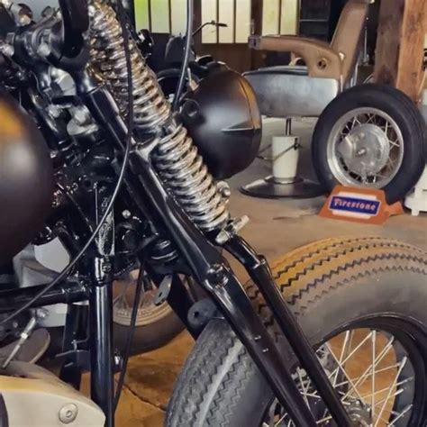 A Close Up Of A Motorcycle Parked In A Garage Next To Other Motorcycles