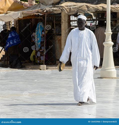 Unidentified Senegalese Man In White Traditional Clothes Walks