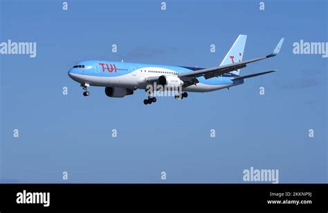 Descending Boeing 767 TUI Airlines Airplane Flying Through Blue Sky