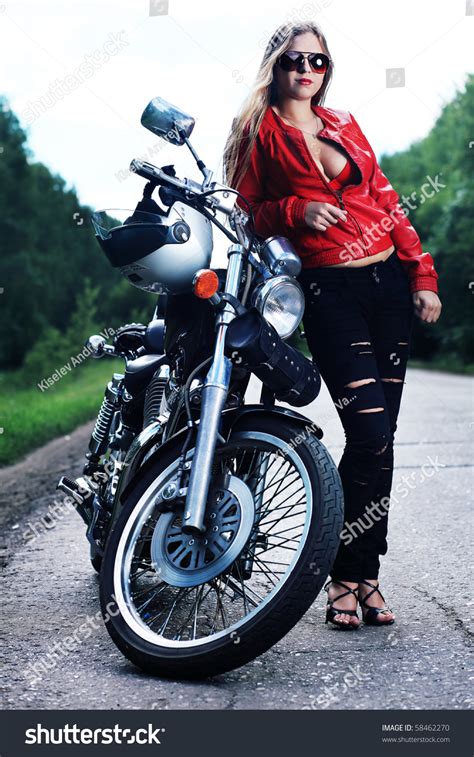 Shot Of An Attractive Woman Biker Posing On Her Motorcycle Stock Photo