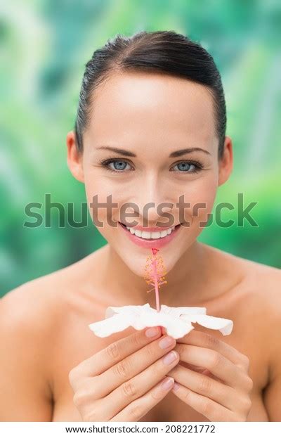 Beautiful Nude Brunette Smelling Lily Looking Stock Photo