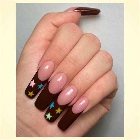 Brown French Tip Nails With Multicolored Stars On Every Other Nail