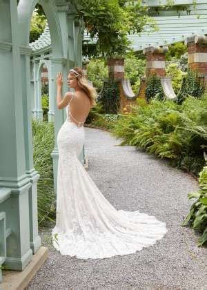 A Woman In A Wedding Dress Leaning Against A Gazebo With Her Hand On