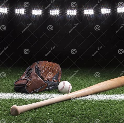 Baseball Mitt Ball And Bat At Night Under Stadium Lights Stock Photo