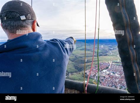 Hot Air Balloon Pilot Flying In Balloon Pointing Out The Sights Stock